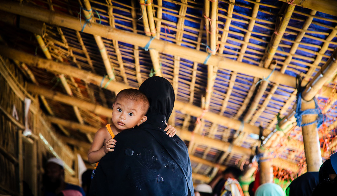 a child being held by a woman in religious covering