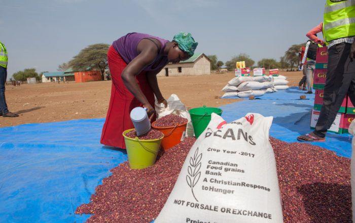 African woman sorting beans from Canadian Foodgrains Bank