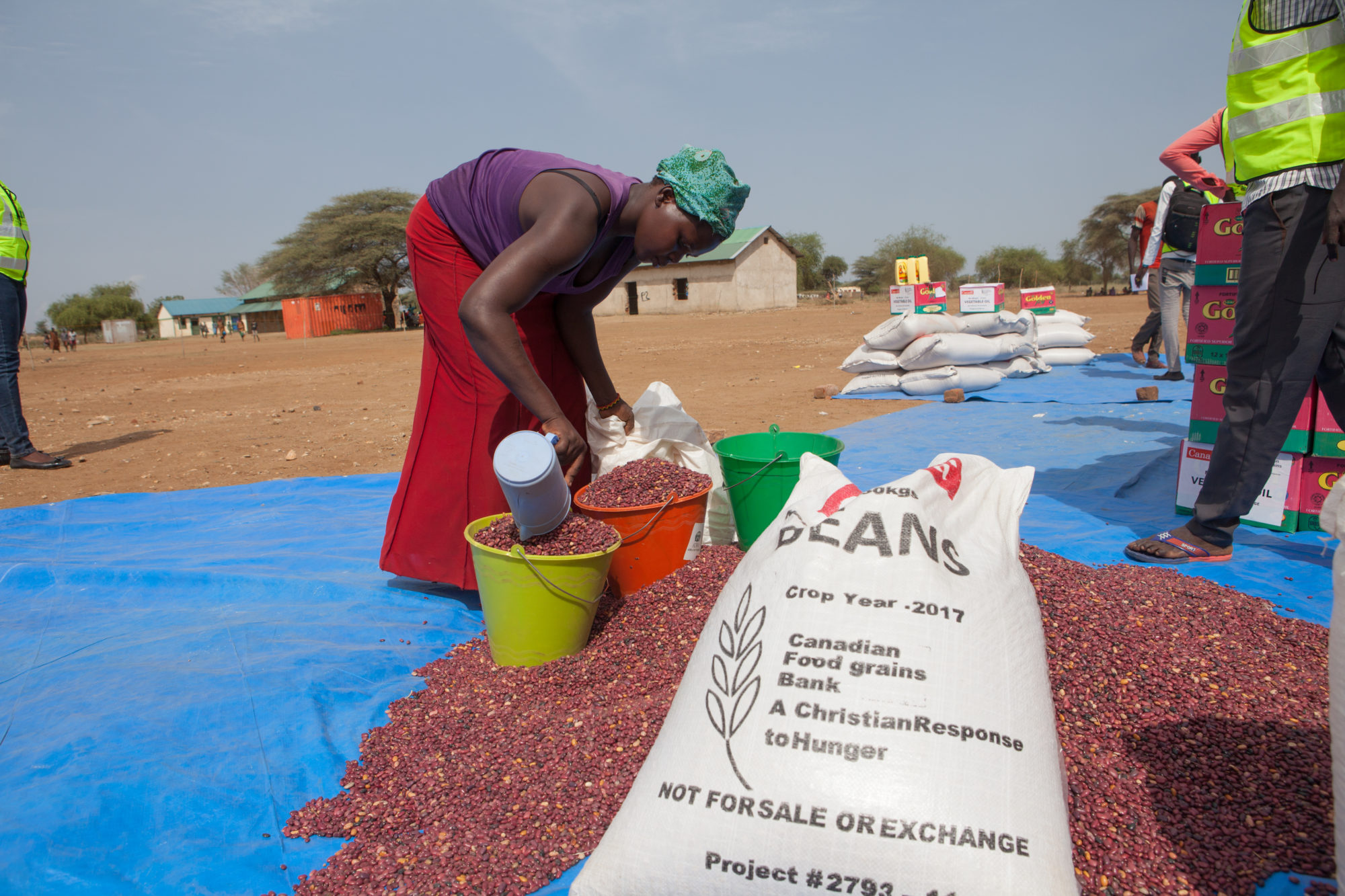African woman sorting beans from Canadian Foodgrains Bank