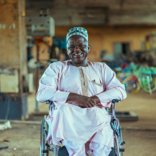 A man in a wheelchair smiles