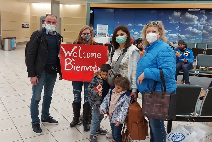 Refugee family being welcomed to Canada by sponsors