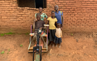 Ng’oma family in Malawi standing in front of their house.
