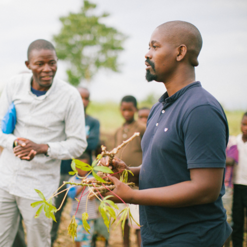 Man teaches agriculture to a community.
