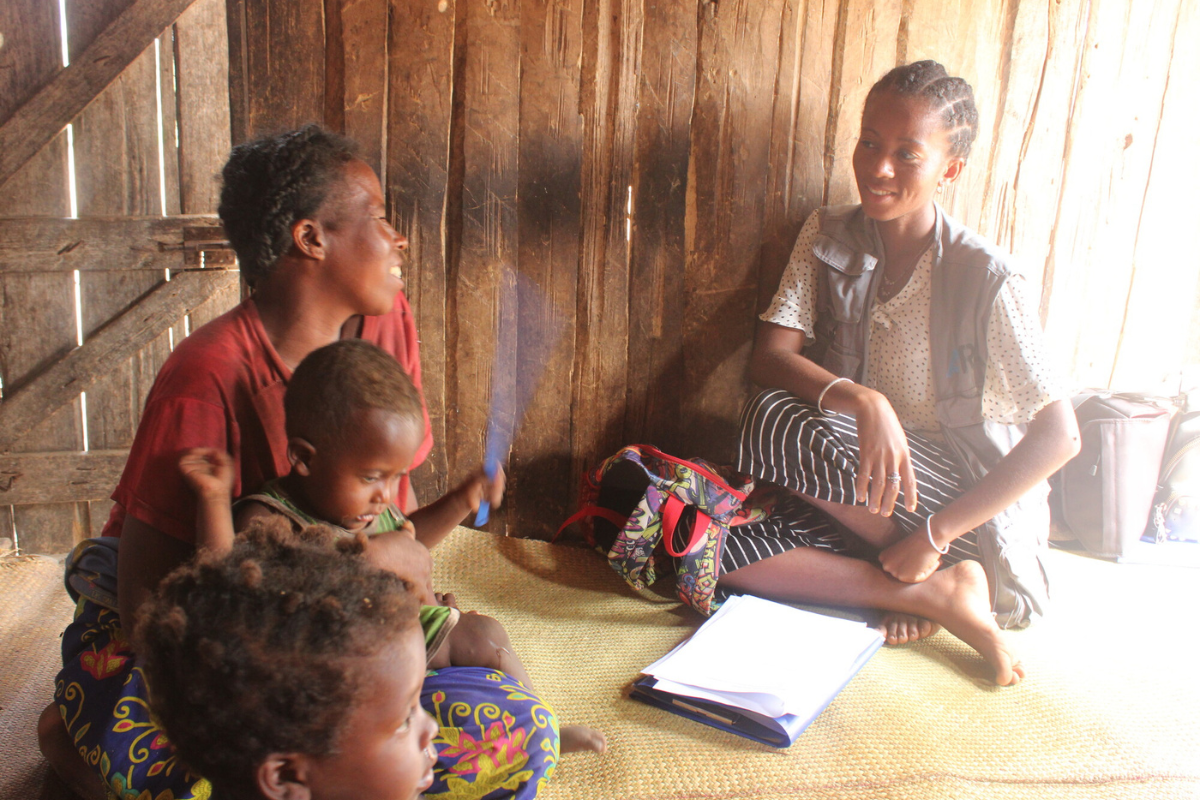 A mother and her children meet with program staff.
