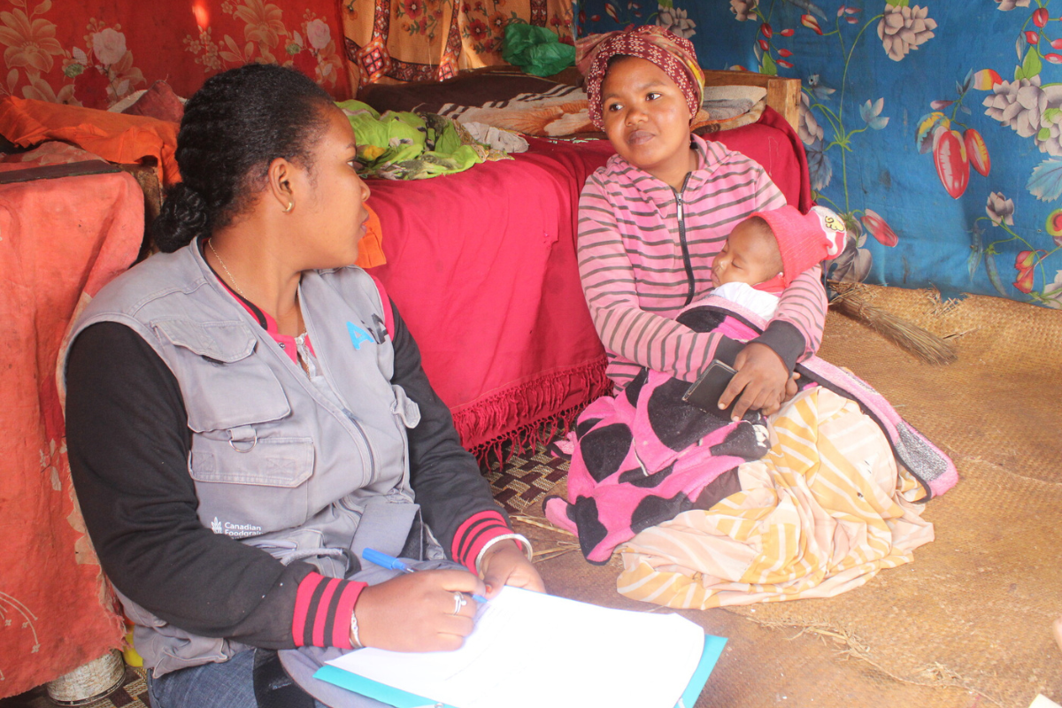 A mother and her baby talk with partner staff.