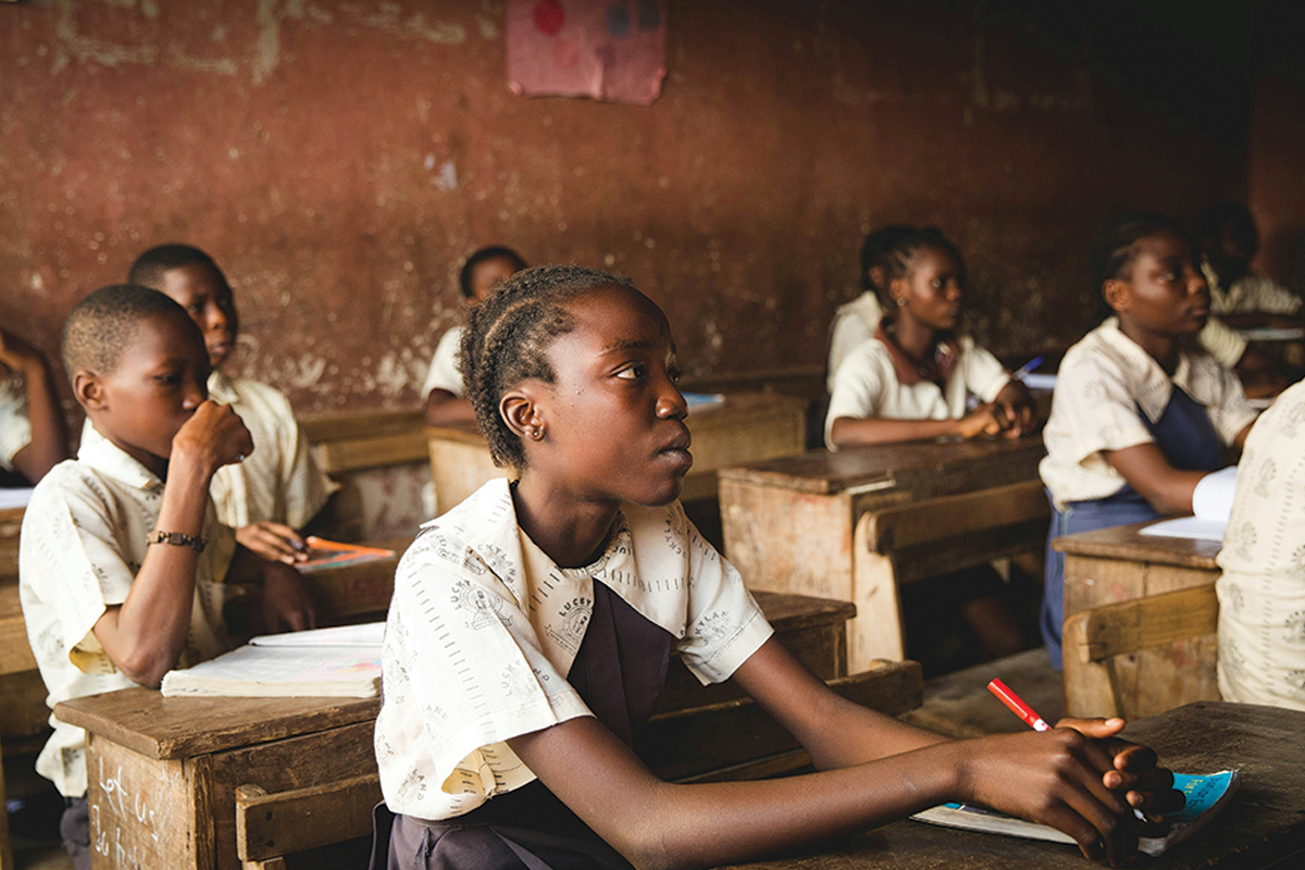 Students in Malawi sit at their desks to learn.