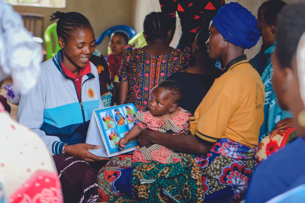 A volunteer supports a mother and baby's health