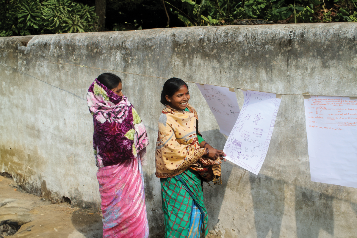 Two women giving a presentation with posters