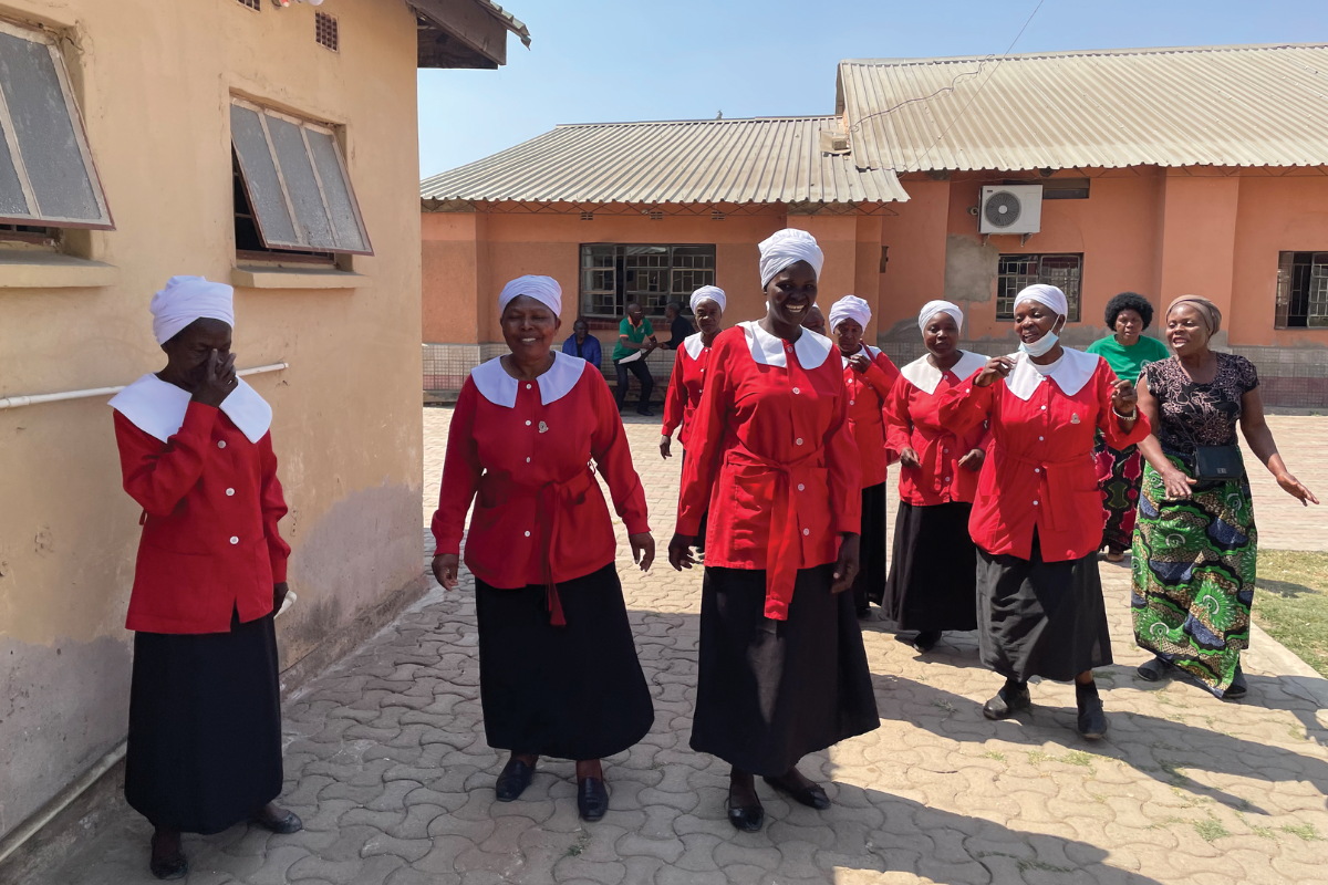 Women wearing red at a trauma healing session