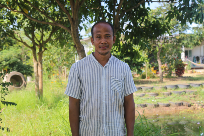 Keo standing in front of a field