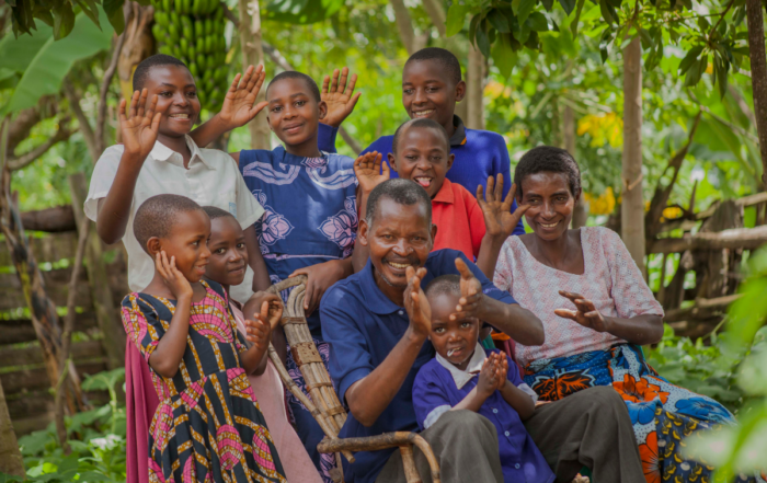 A family smiles and waves