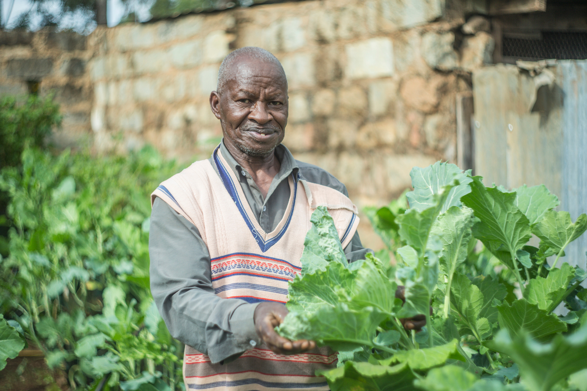 A farmer stands with his vegetables