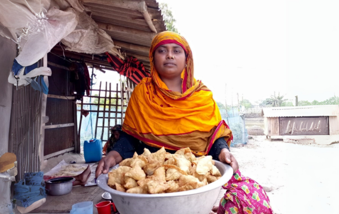 A woman with snacks she sells at market