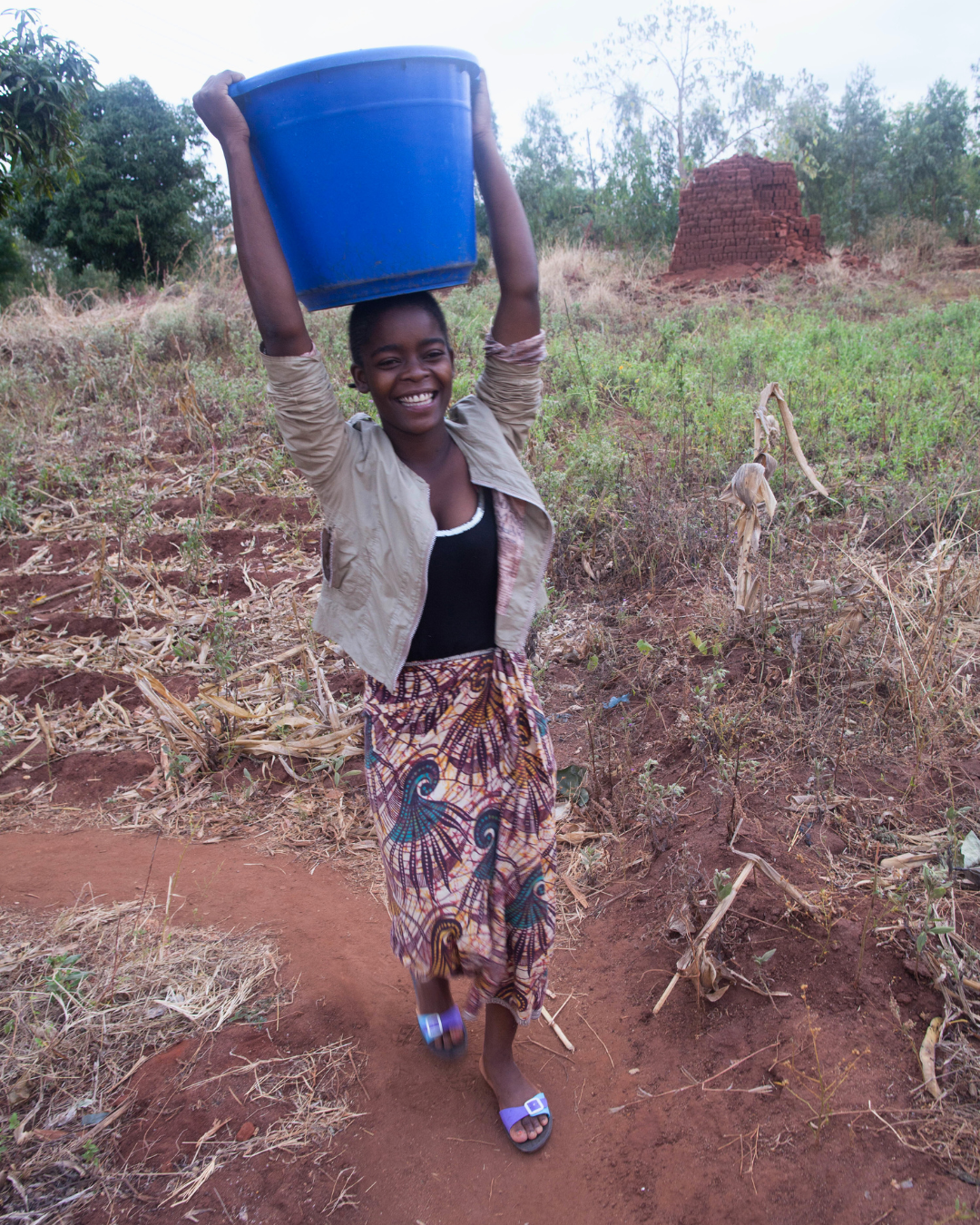 A girl carries water