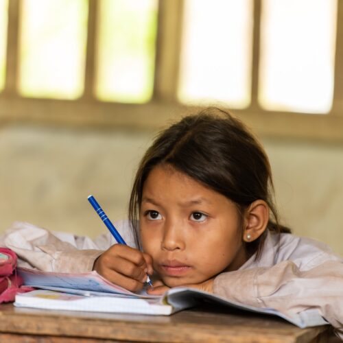 A girl writes in a notebook