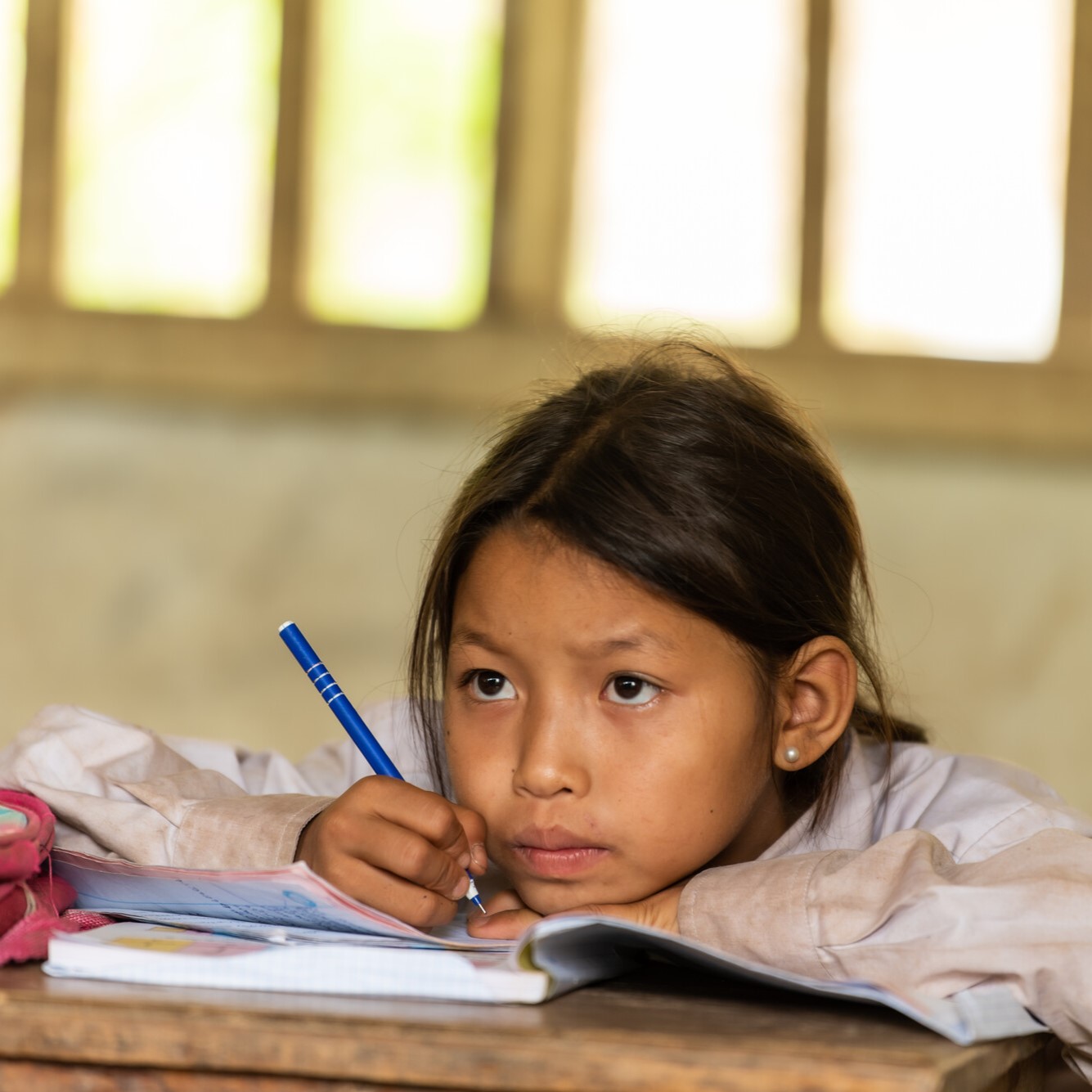 A girl writes in a notebook