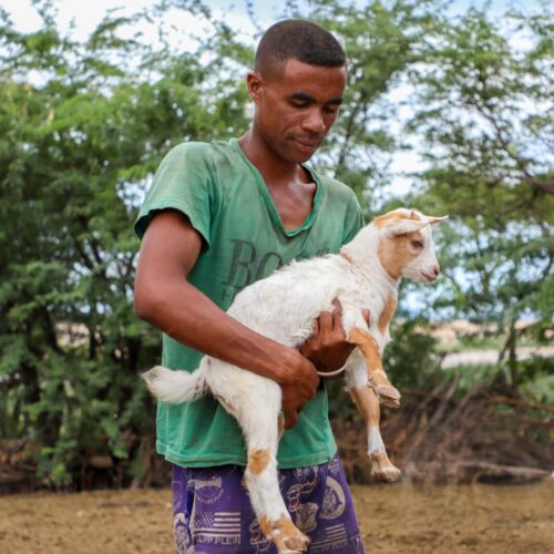 man holding goat