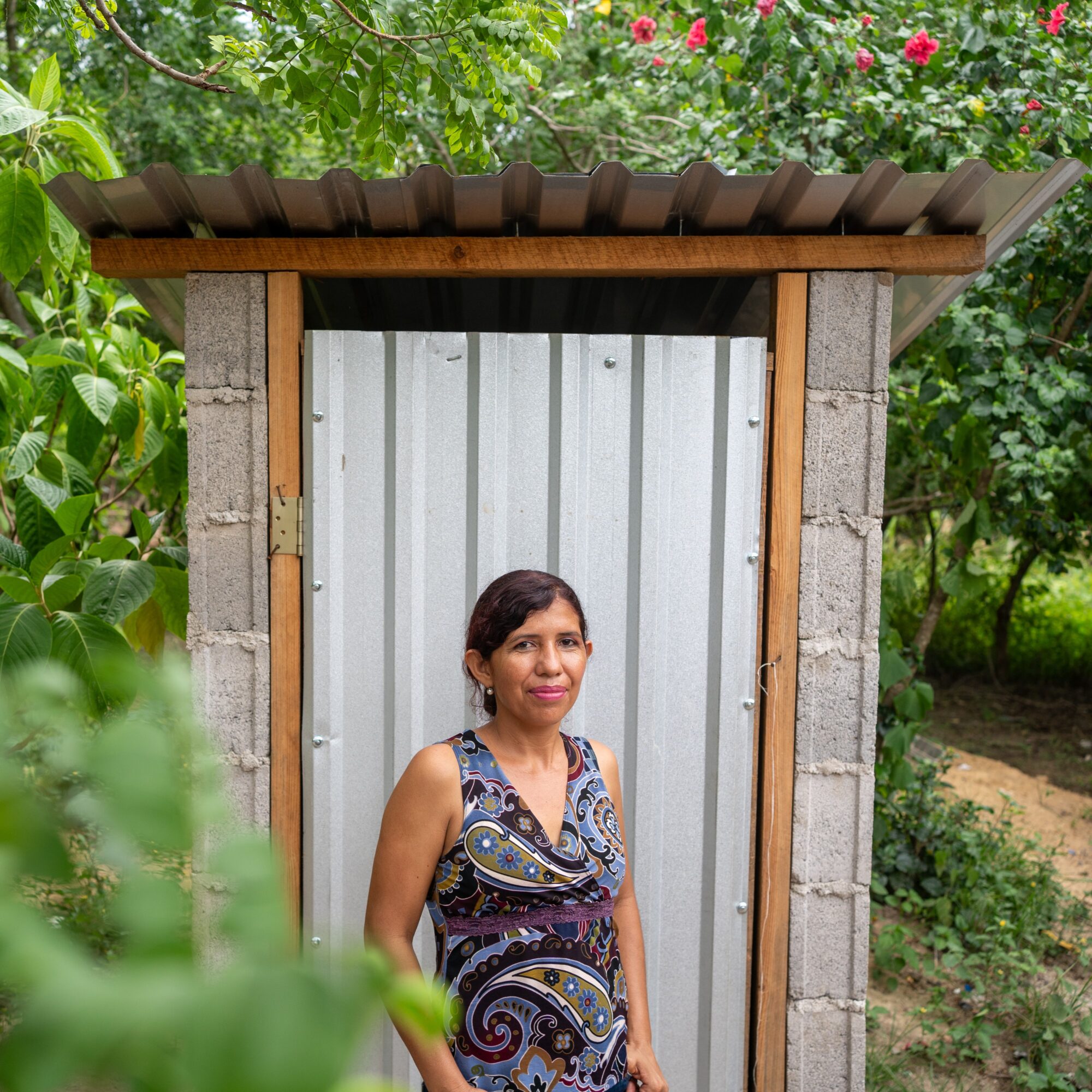 woman standing in front on latrine