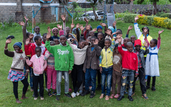Kids at a Youth Running Club wave