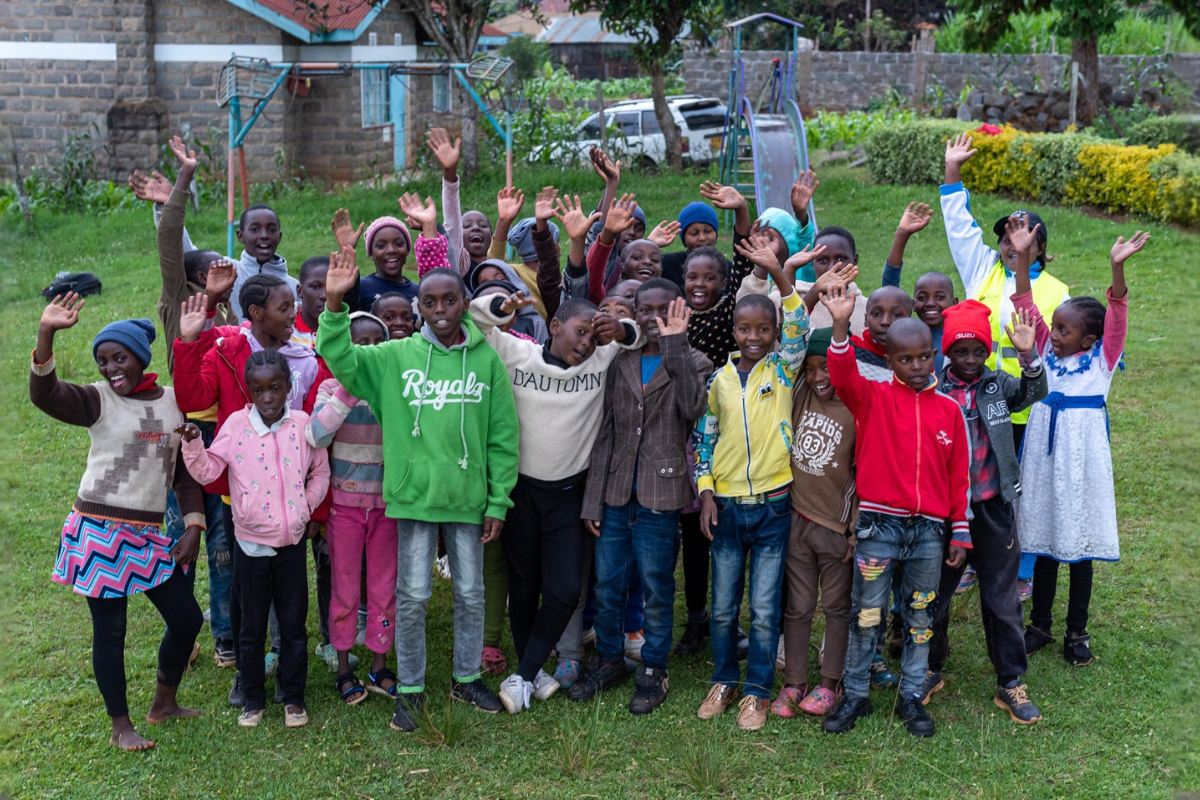 Kids at a Youth Running Club wave