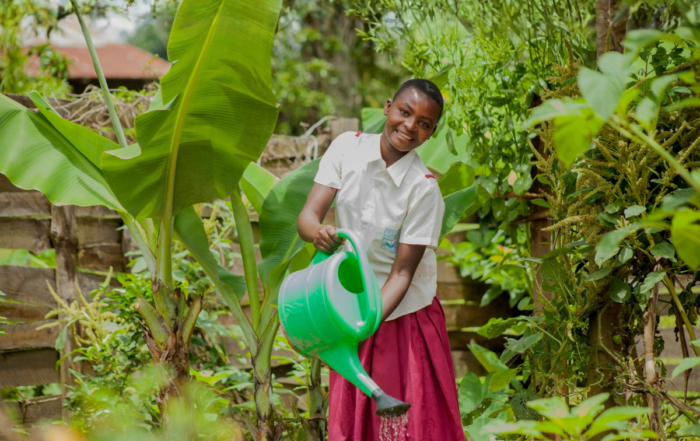 A woman waters plants